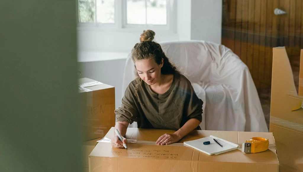 woman labeling a box