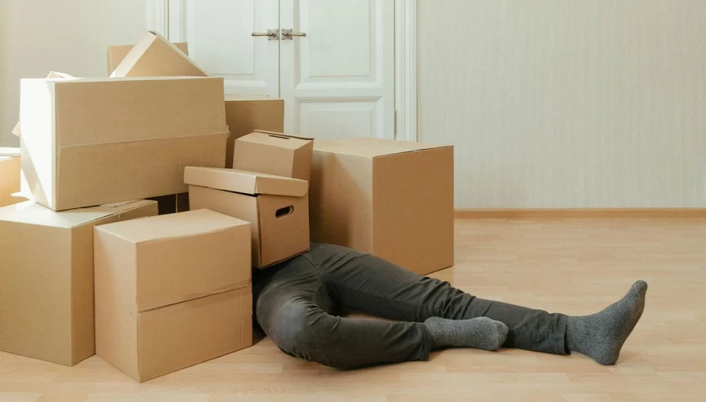 man covered in boxes