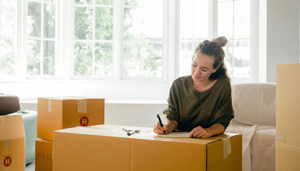 woman on writing notes on boxes
