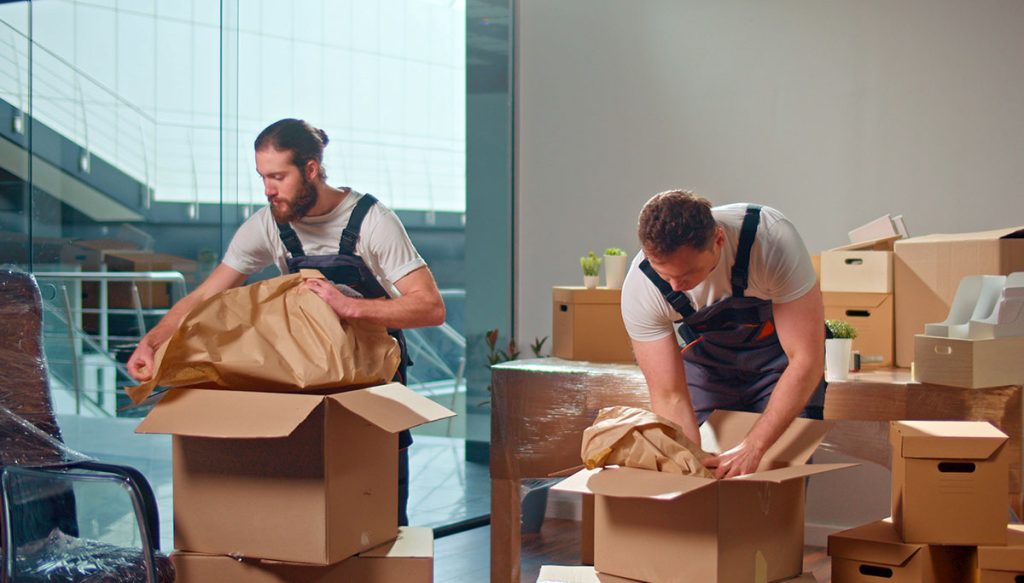 Professional Movers packing office items in boxes