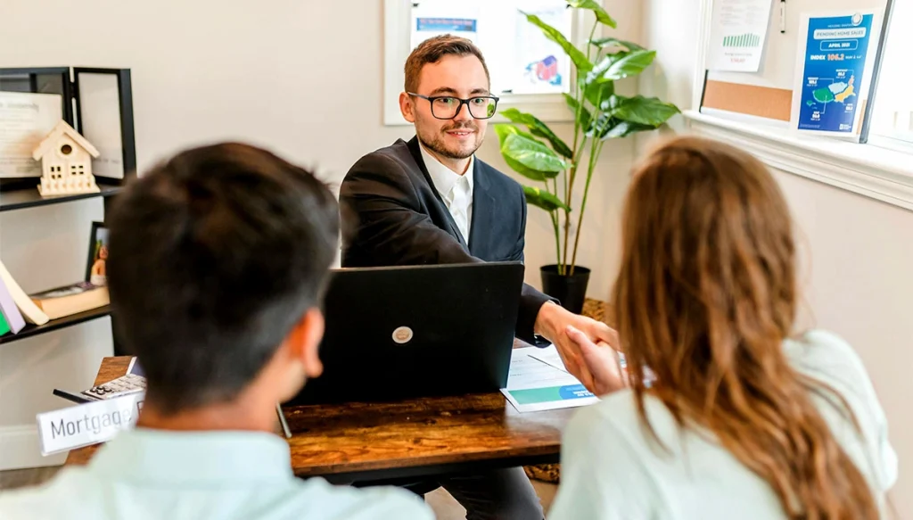 A broker meeting with clients