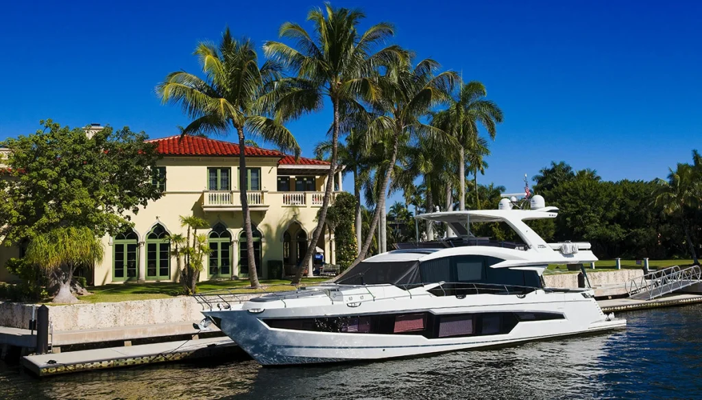 yacht parked in the backyard of a large home