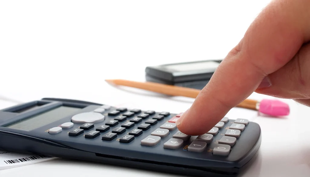 finger pressing buttons on a calculator
